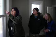 Real estate agent Lydia Kauppi talks with clients Carrin Baumgartner and Martin McNulty as they tour a home for sale Feb. 25 in Northeast Minneapolis.