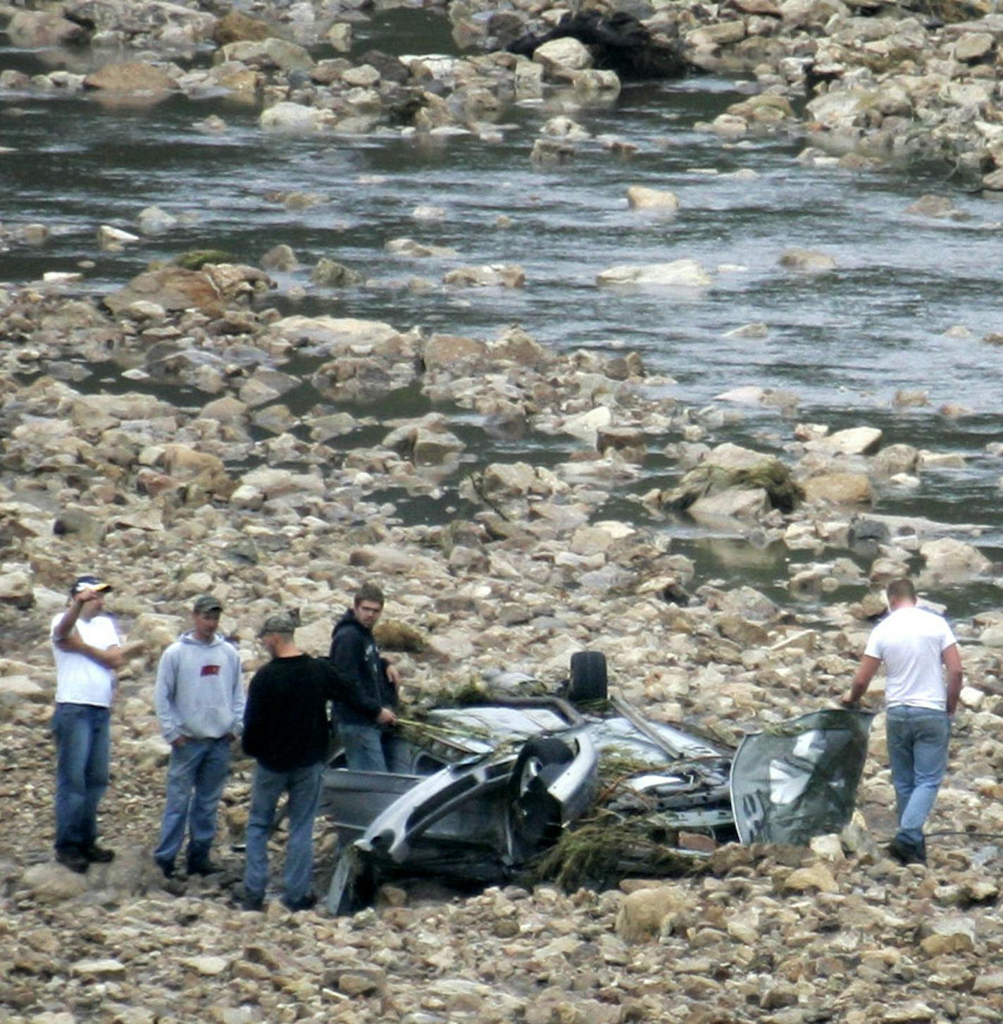 BRIAN PETERSON &#x2022; Brianp@startribune.com
Rushford, MN - 8/19/2007
A car found in Rush Creek south of I-90 west of Wilson is believed to have been occupied, a Hwy patrol officer near the scene said they have a missing person related to the car and were planning to search the river.
(In this photo) A group of men look over the scene at about 12:30 pm Sunday.