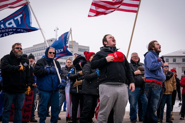 People sang the National Anthem during a rally supporting President Trump at the Minnesota Capitol.