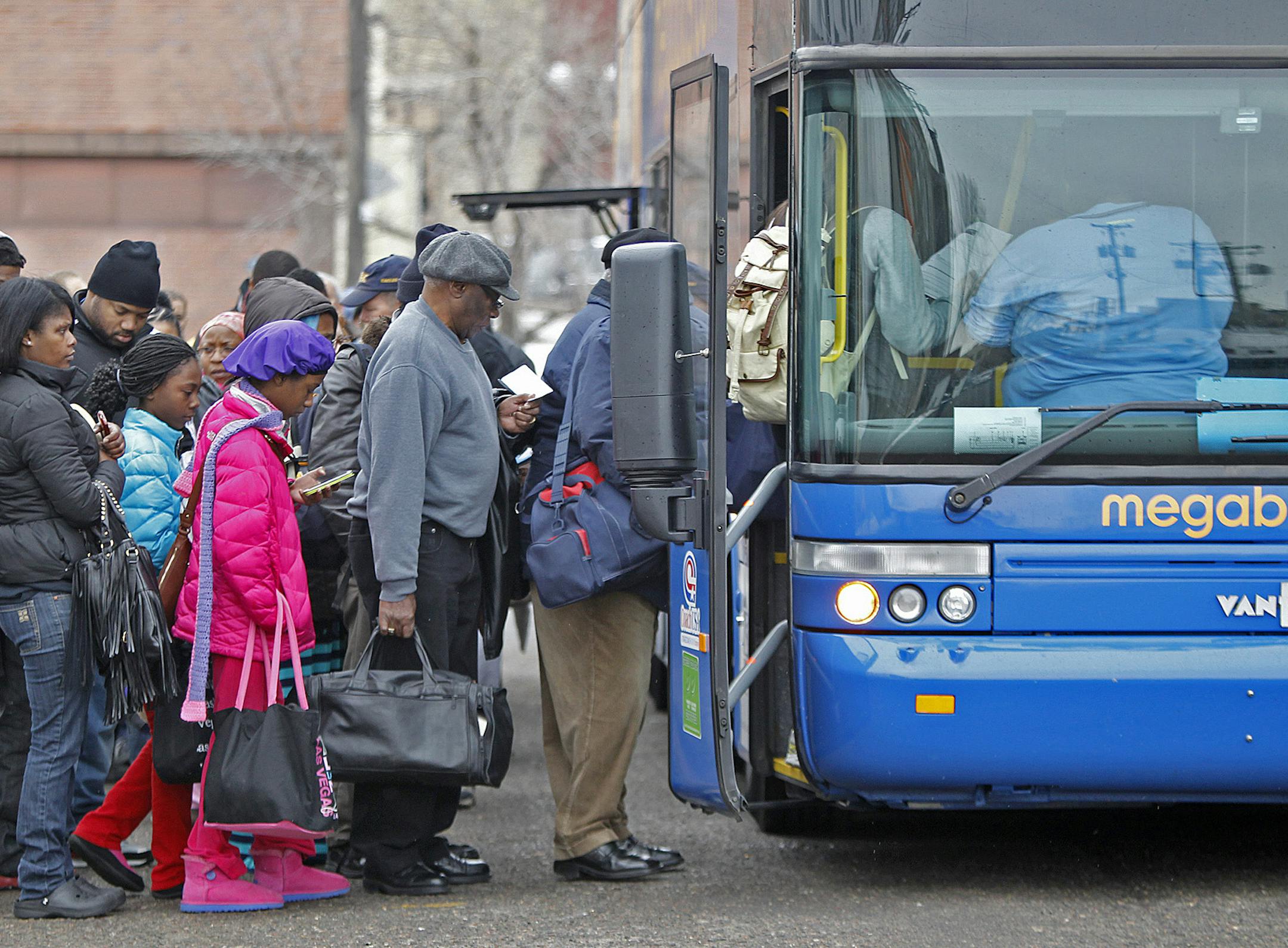 Passengers made their way onto the Megabus at a pick-up location near the corner of Washington and Chicago Avenues in downtown Minneapolis, MN, Friday, March 29, 2013. (ELIZABETH FLORES/STAR TRIBUNE) ELIZABETH FLORES &#x2022; eflores@startribune.com