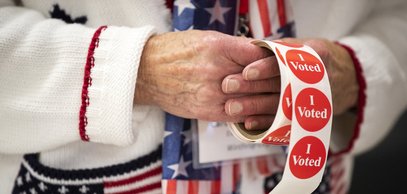 Election official Carol Messner gives out stickers at Winthrop Community Hall. ] LEILA NAVIDI &#xa5; leila.navidi@startribune.com BACKGROUND INFORMATION: Election Day voting in Sibley County on Tuesday, November 6, 2018. At 91.4 percent, in 2016, Sibley County had one of the highest percentage of votes cast at a polling place of any county in the state.