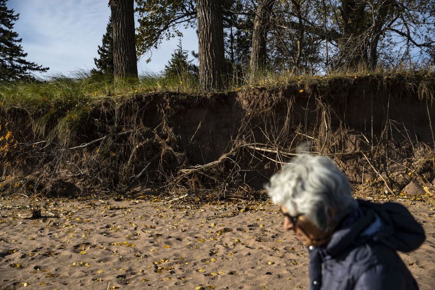 Jan Karon walked along Park Point beach showing how all of her neighbors have attempted to deal with the erosion and large waves from Lake Superior.