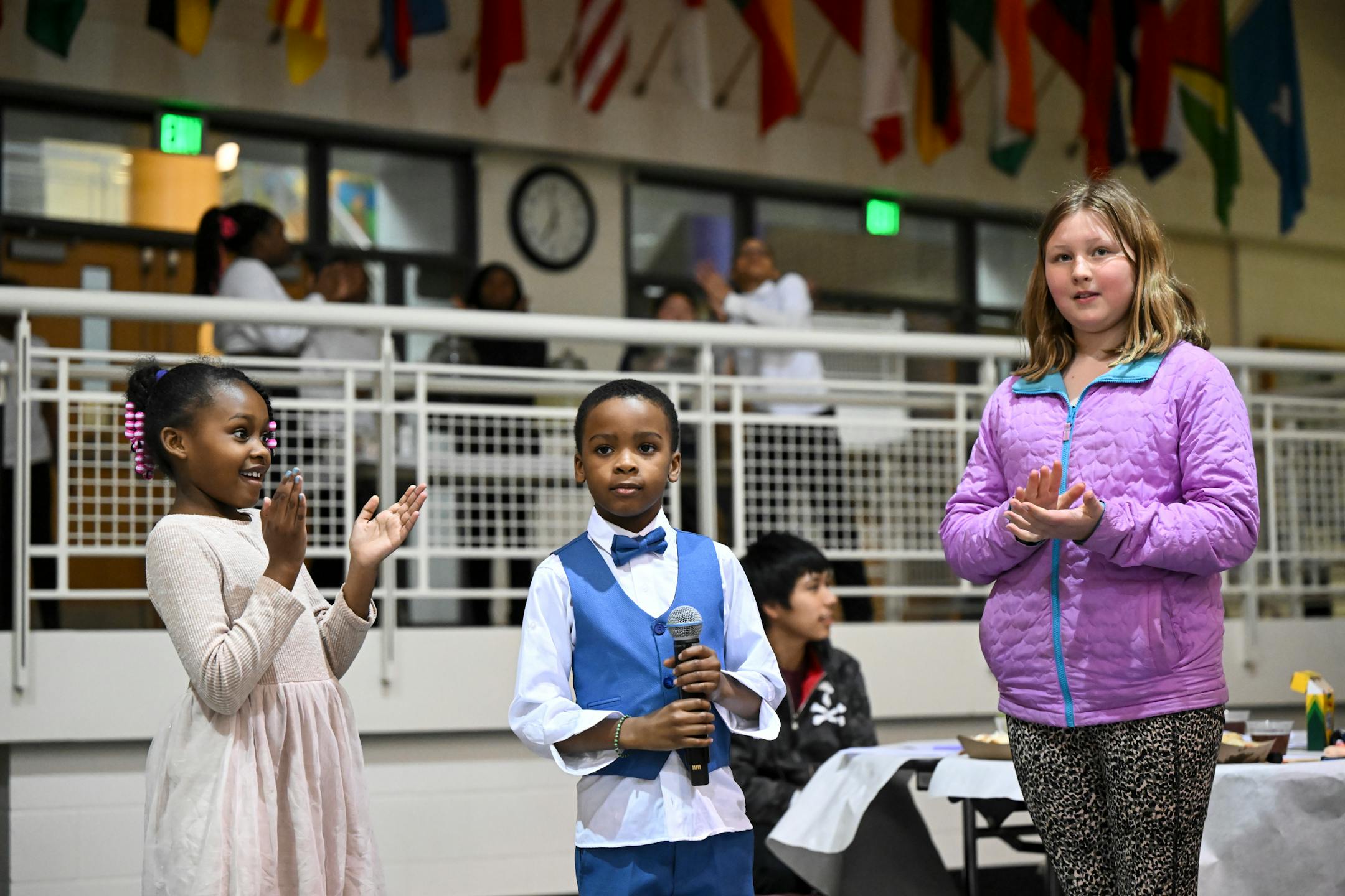 Micheal Bracey, 7, earns the applause of his niece, Jabria Overton, 6, and Ruby Preusse, 11, after Bracey correctly answered what the difference is between a school lockdown and a school lock-in.