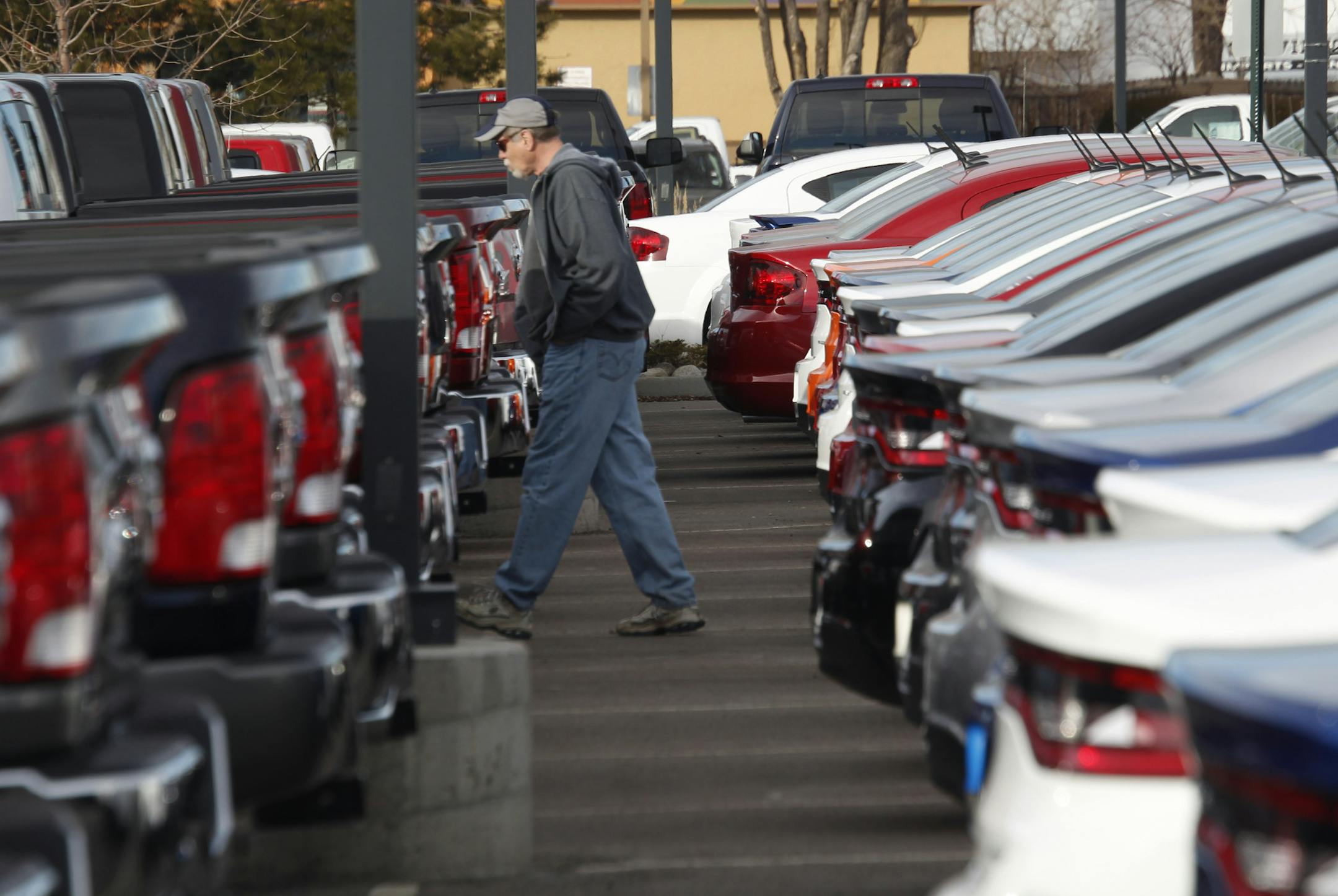 FILE - In this Sunday, Jan. 20, 2013 file photo, a buyer moves between rows of 2013 Ram pickup trucks and Dart sedans at a Dodge dealership in Littleton, Colo. Chrysler's U.S. sales rose 11 percent in May, a sign that auto sales rebounded from a slight dip in April and will continue to boost the U.S. economy. Ram pickup truck sales were strong, up 22 percent over a year ago to almost 32,000. (AP Photo/David Zalubowski, File)
