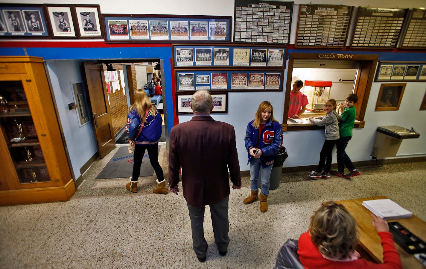 Coach Bob McDonald stopped to look at some of the basketball trophies on display in the Chisholm High hallways in 2013..