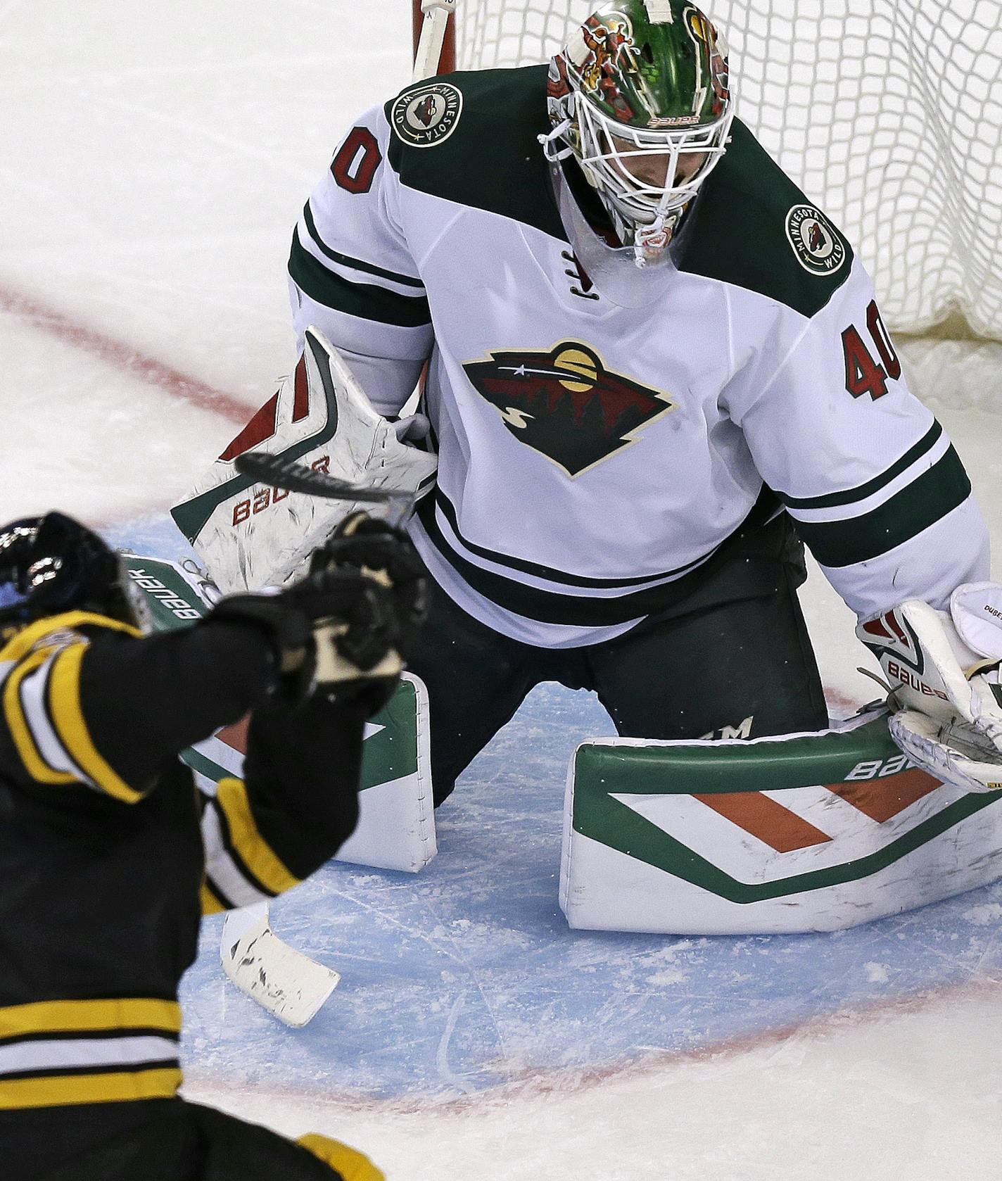 Boston Bruins left wing Loui Eriksson shoots his third goal of the game past Minnesota Wild goalie Devan Dubnyk (40) during the third period of an NHL hockey game in Boston Thursday, Nov. 19, 2015. (AP Photo/Charles Krupa)