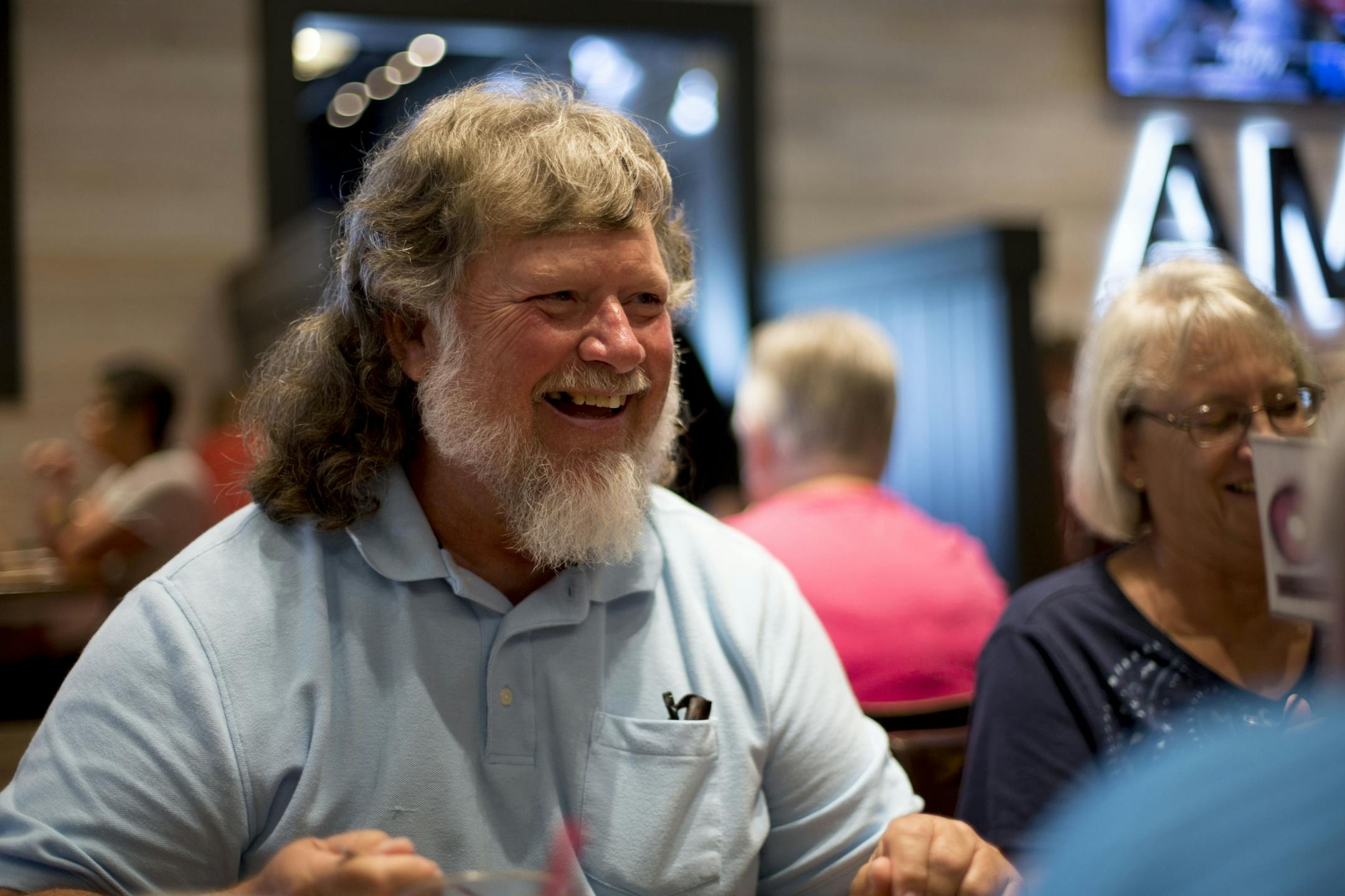 Bruce Weise laughs with friends over lunch at Famous Dave's on Thursday.
