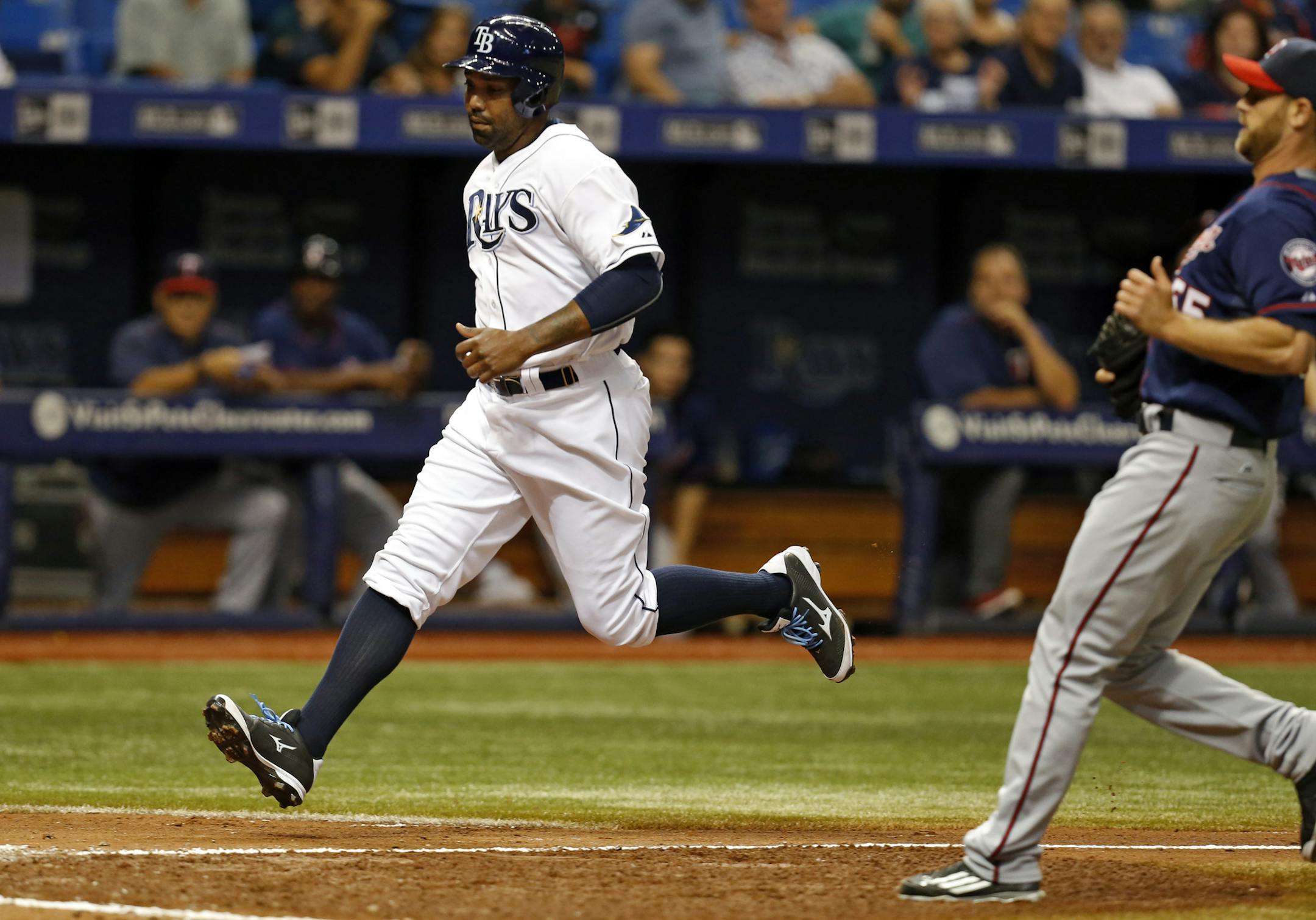 Tampa Bay Rays' Joey Butler scores on a passed ball as Minnesota Twins relief pitcher Neal Cotts covers during the sixth inning of a baseball game Thursday, Aug. 27, 2015, in St. Petersburg, Fla. The Rays won 5-4. (AP Photo/Mike Carlson)