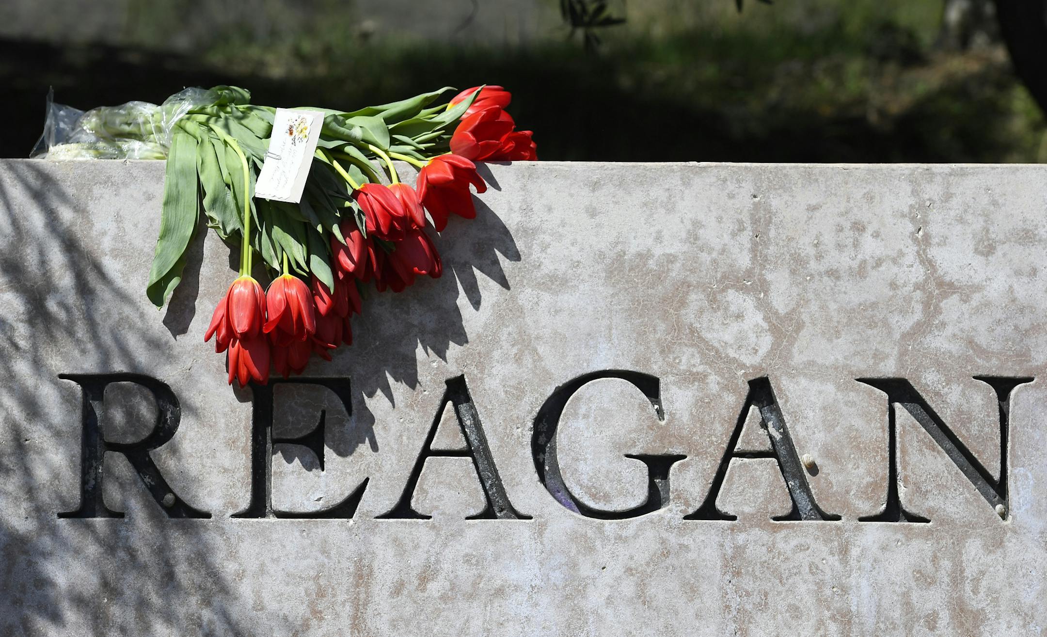 Flowers sit atop the sign at the entrance to the Ronald Reagan Presidential Library, Sunday, March 6, 2016, in Simi Valley, Calif. Former first lady Nancy Reagan died today at 94. (AP Photo/Mark J. Terrill)
