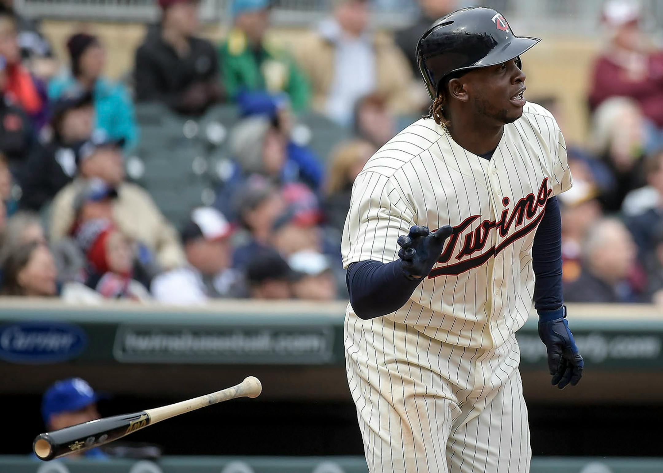 Minnesota Twins third baseman Miguel Sano (22) tossed his bat after hitting a triple, brining home Brian Dozier, Max Kepler and Joe Mauer in the bottom of the seventh inning.