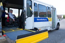 Mark Hughes boards a Metro Mobility van outside the library in Woodbury on Friday.



The Metro Mobility van was scheduled to arrive at the pickup loc