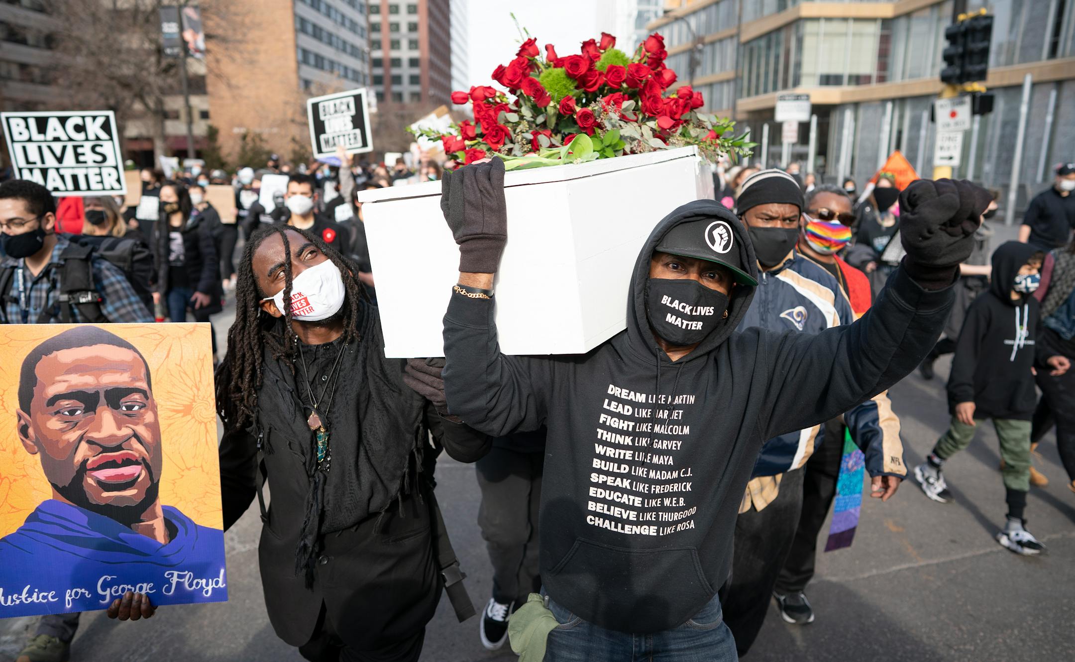 Cortez Rice, left, a friend of George Floyd, and Raj Sethuraju carried a coffin to mourn the murder of George Floyd during a rally.