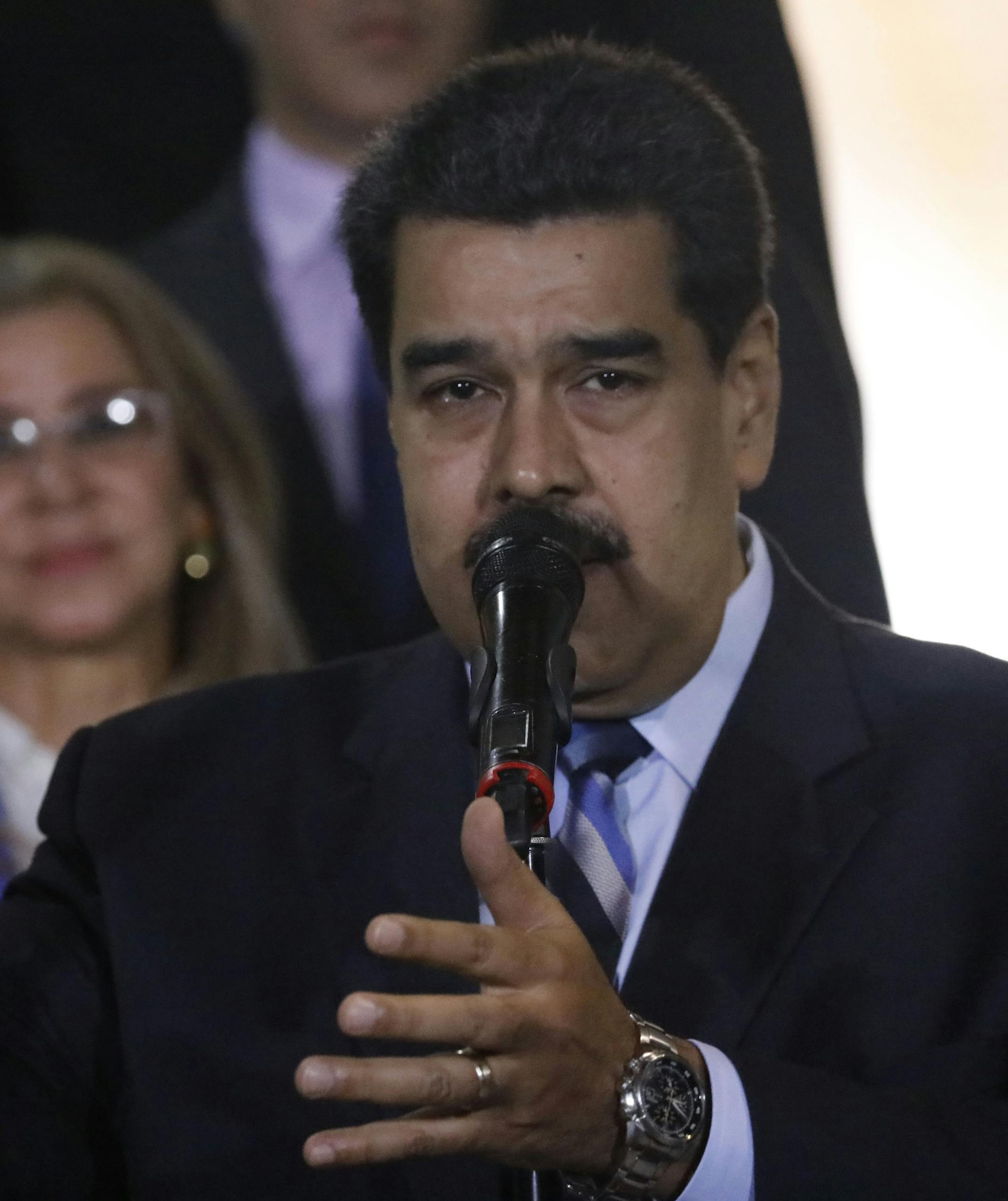 With first lady Cilia Flores in the background, Venezuela's President Nicolas Maduro speaks to the press after a meeting with U.N. High Commissioner for Human Rights Michelle Bachelet at Miraflores Presidential Palace, in Caracas, Venezuela, Friday, June 21, 2019. The United Nations' top human rights official is visiting Venezuela amid heightened international pressure on President Maduro. (AP Photo/Ariana Cubillos)