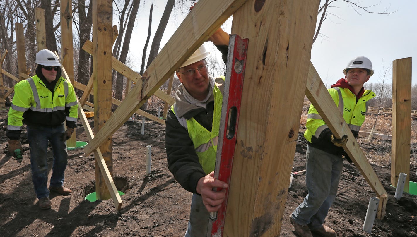 (left to right) Brent Karvonen, Paul Keranen and Chad Zink of Blackstone Construction worked on an elevated platform, on 4/9/14, as St. Louis Park and Minnehaha Creek Watershed District installing paths and a boardwalk along a stretch of the creek that until now hasn't been accessible to anyone other than canoeists and kayakers. The construction is taking place near the Izaak Walton Creekside Park in St. Louis Park.] Bruce Bisping/Star Tribune bbisping@startribune.com Paul Keranen, Brent Karvone