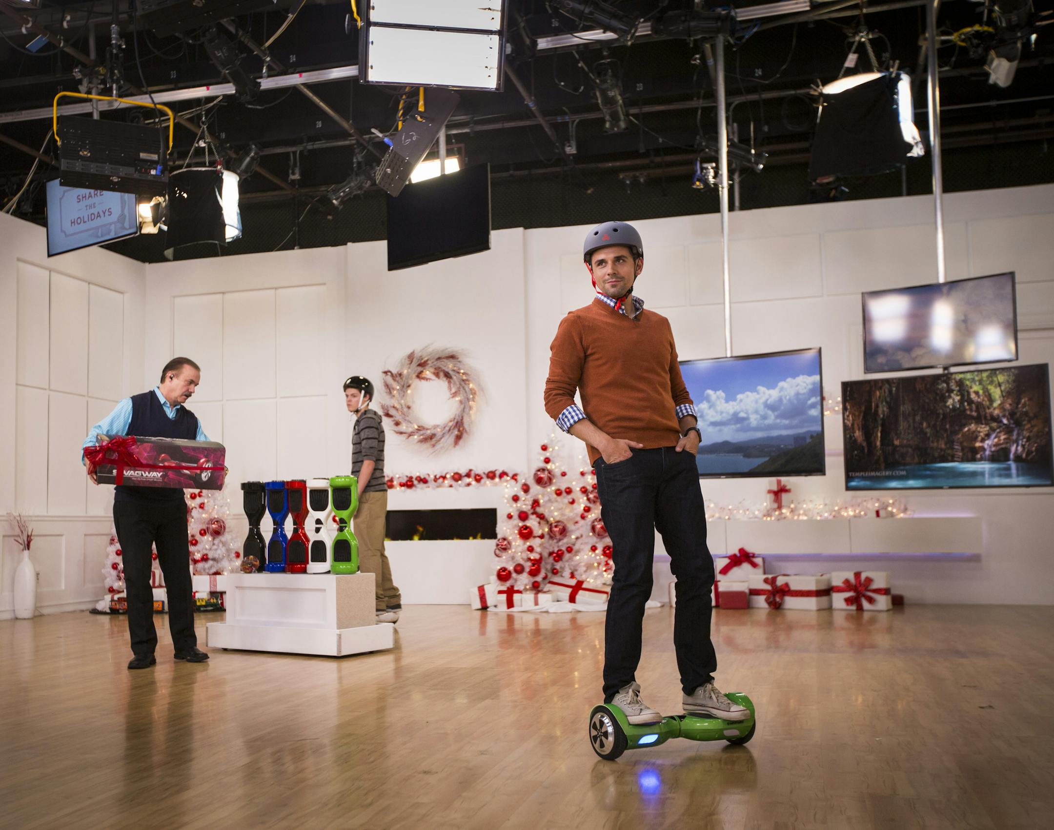 Evine Live, the Eden Prairie-based home shopping network, did a segment on Swagway, or self-balancing scooters, on Tuesday, November 17, 2015, in Eden Prairie, Minn. Pictured are hosts Sasha Andreev (at right on Swagway) and Skip Connelly (left) and guest Nick Ryan (center).] RENEE JONES SCHNEIDER • reneejones@startribune.com