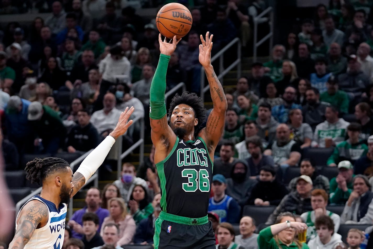 Boston Celtics guard Marcus Smart (36) takes a shot at the basket past Minnesota Timberwolves guard Jordan McLaughlin (6) in the first half of an NBA basketball game, Sunday, March 27, 2022, in Boston. (AP Photo/Steven Senne)