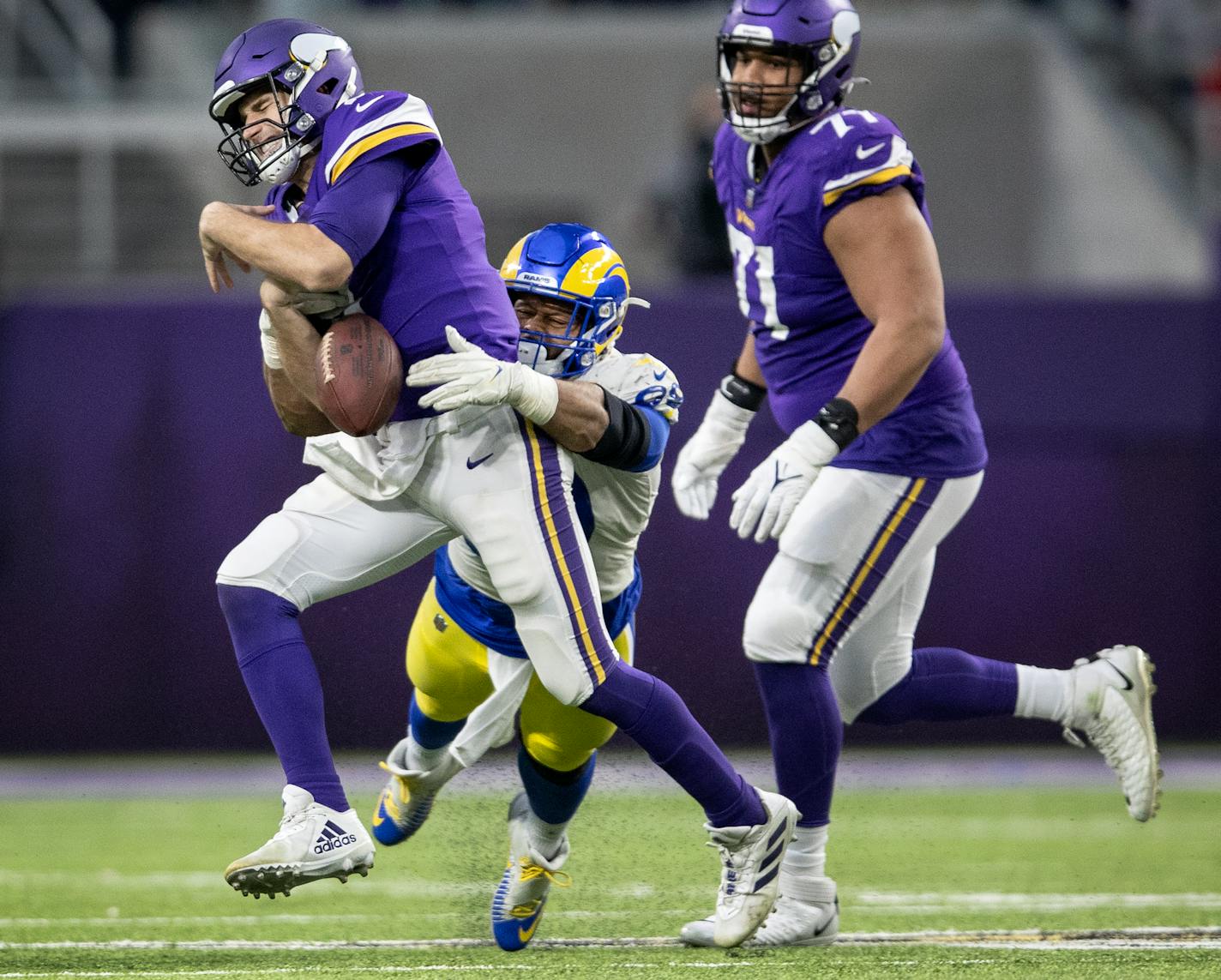 Aaron Donald (99) of the LA Rams forces Minnesota Vikings quarterback Kirk Cousins (8) to fumble in the fourth quarter Sunday, Dec. 26, 2021 at U.S. Bank Stadium in Minneapolis, Minn. ] CARLOS GONZALEZ • cgonzalez@startribune.com