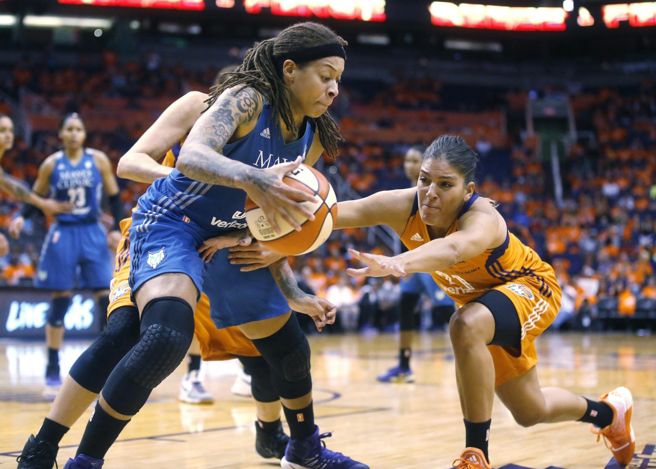 Phoenix Mercury Marta Xargay, right, attempts to steal the ball from Minnesota Lynx Seimone Augustus during game 3 of the WNBA basketball semifinals in Scottsdale, Ariz., Sunday, Oct. 2, 2016.