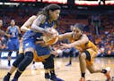 Phoenix Mercury Marta Xargay, right, attempts to steal the ball from Minnesota Lynx Seimone Augustus during game 3 of the WNBA basketball semifinals i