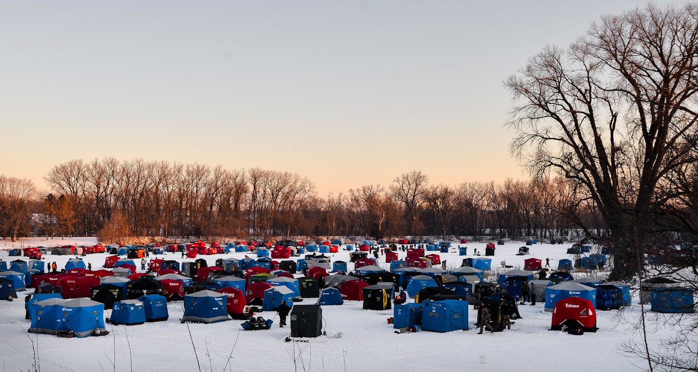 Hundreds of fishermen set up ice houses on Courthouse Lake, nestled behind the Carver County Government Center, before sunrise Saturday, Jan. 14. ] (LIZ SAWYER/STAR TRIBUNE) liz.sawyer@startribune.com Anglers made the annual pilgrimage to Chaska's Courthouse Lake on Saturday, Jan. 14, 2017 for the winter trout season opener.