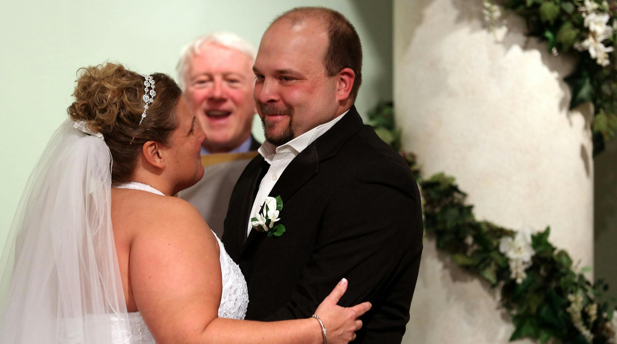 Angel Bustad, left, and her husband Troy Jones smiled after kissing during their wedding at the Chapel of Love at the Mall of America Tuesday.
