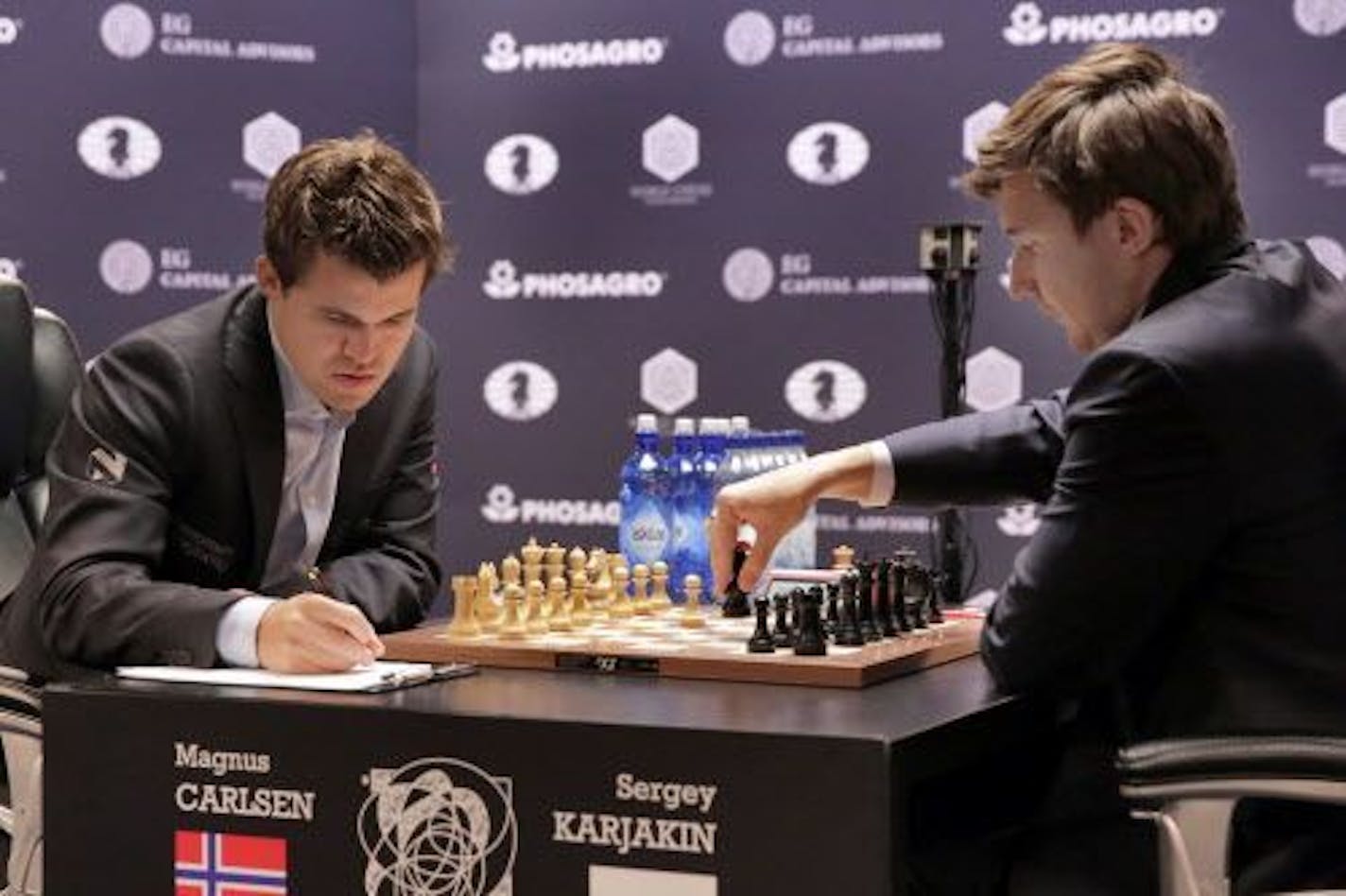 Sergey Karjakin, right, makes a move during round 8 of the World Chess Championship against Magnus Carlsen, in New York, Monday, Nov. 21, 2016.