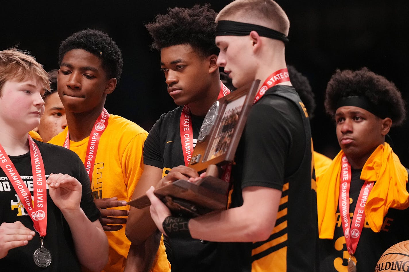 DeLaSalle players gathered their second place trophy after losing the MSHSL boys basketball Class 3A state championship game between Totino-Grace and DeLaSalle Saturday, March 26, 2022 at Williams Arena in Minneapolis. ] ANTHONY SOUFFLE • anthony.souffle@startribune.com