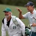 Justin Rose and his caddie David Clark react to his second shot on the eighteenth hole during the first round of the Masters golf tournament at August