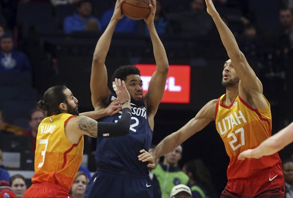 Wolves center Karl-Anthony Towns tried to beat the double-team of Utah's Ricky Rubio, left, and Rudy Gobert in the first half Sunday.