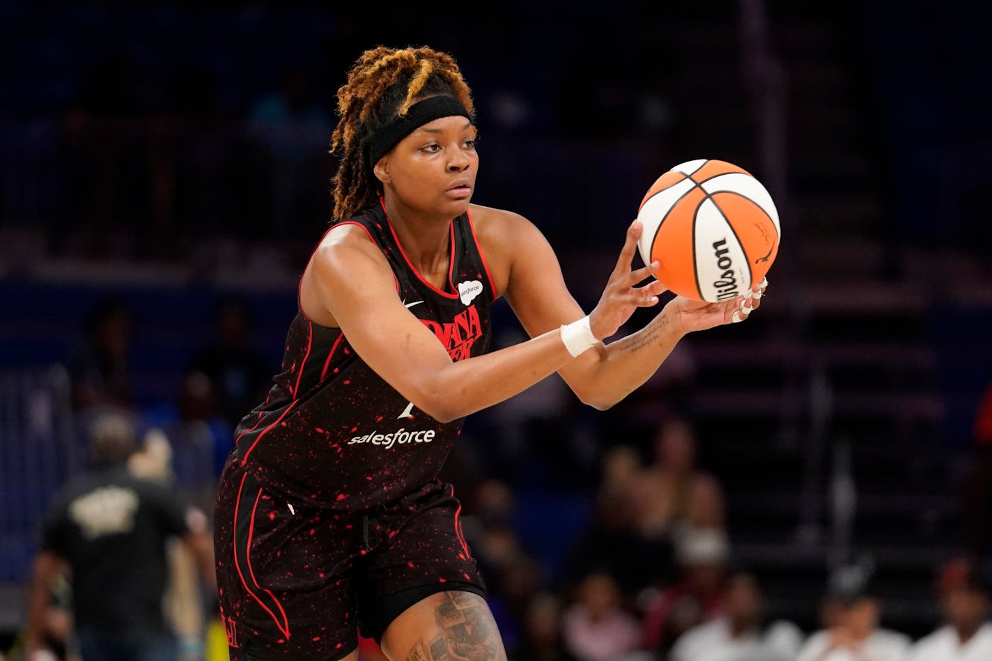 Indiana Fever's NaLyssa Smith makes a pass during a WNBA basketball game against the Dallas Wings, Friday, June 24, 2022, in Arlington, Texas. (AP Photo/Tony Gutierrez)