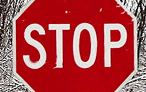 A stop sign is almost buried by several feet in a Fredon, N.J., neighborhood Thursday March 5, 2015, as another storm passes through Sussex County.