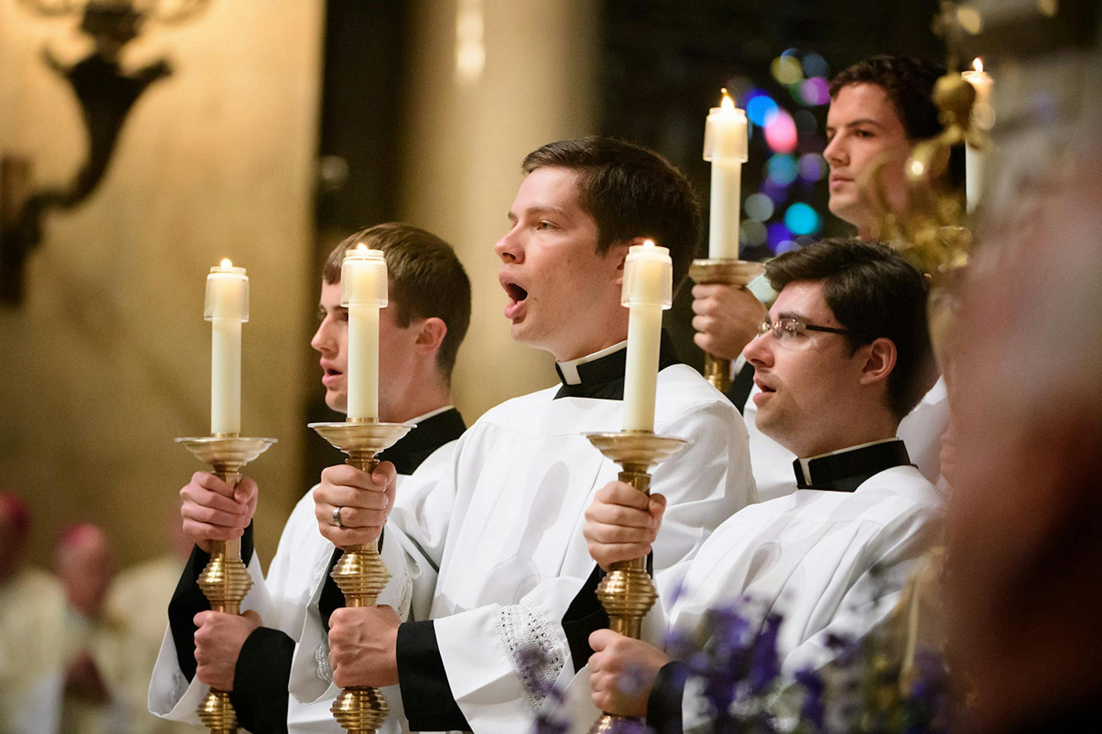 Singing the Gloria as Archbishop Bernard Hebda took his seat at the cathedra or bishops throne on the altar and acknowledged the sustained applause from the crowd.