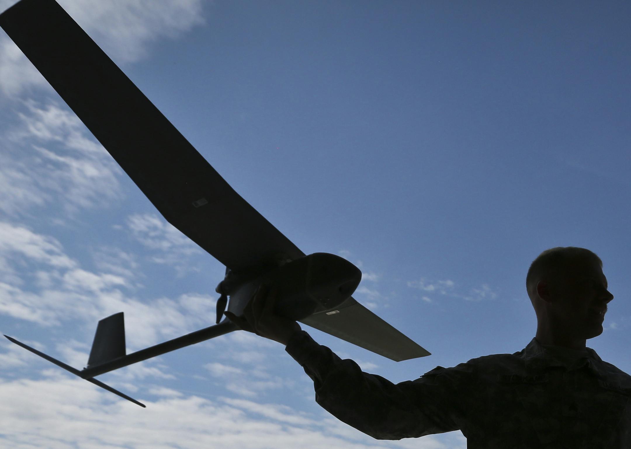 Sgt. Christopher Storkamp held a Raven unmanned aircraft with a camera that can be carried in a backpack and hand launched to scope out potentially dangers situations. Sgt. Storkamp is a Raven master trainer and was part of the grand opening of the Camp Ripley Unmanned Aircraft Systems Operations Facility in Little Falls, Minn., on Friday, May 16, 2013. ] (RENEE JONES SCHNEIDER * reneejones@startribune.com) ORG XMIT: MIN1305171451110239