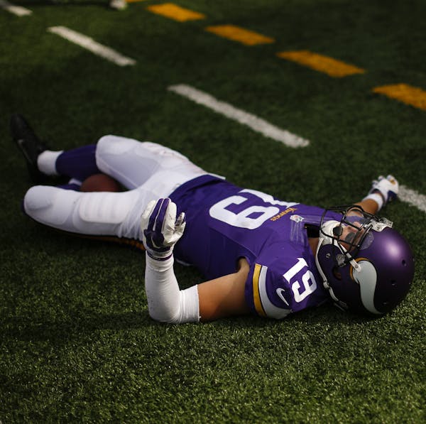 Minnesota Vikings wide receiver Adam Thielen (19) lay on the ground after he dropped a pass in the end zone on the final play of the game Sunday at TC