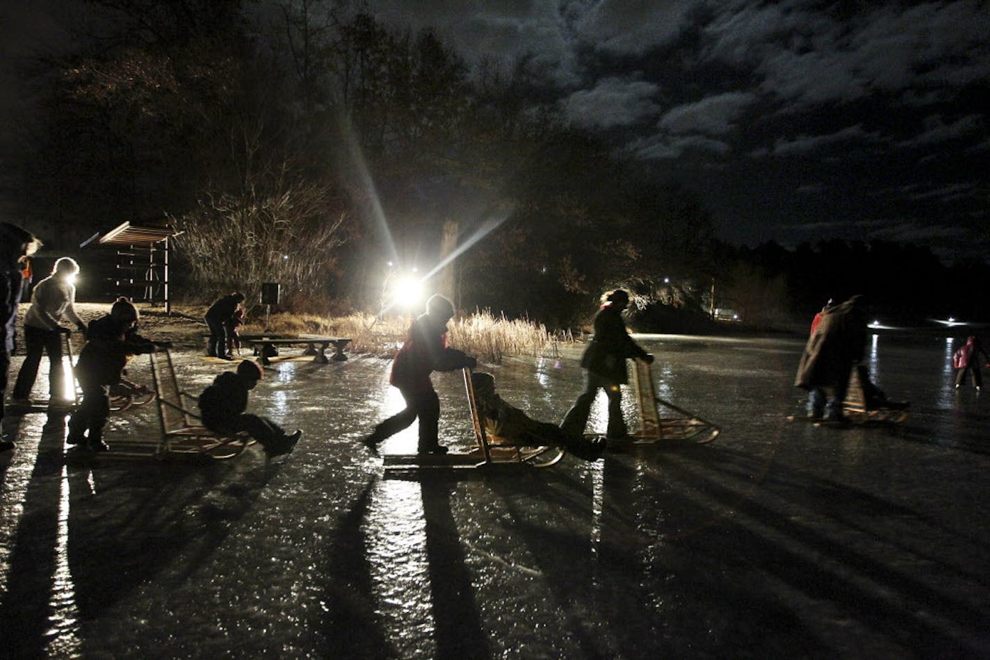 Visitors raced across the ice on kick sleds during a family skate night at Lebanon Hills Regional Park in Eagan January 6, 2012. Dakota County's largest park recently debuted $1.3 million in improvements, including a natural ampitheater, a new parking lot and paved, lit trails connecting the campus. (Courtney Perry/Special to the Star Tribune)