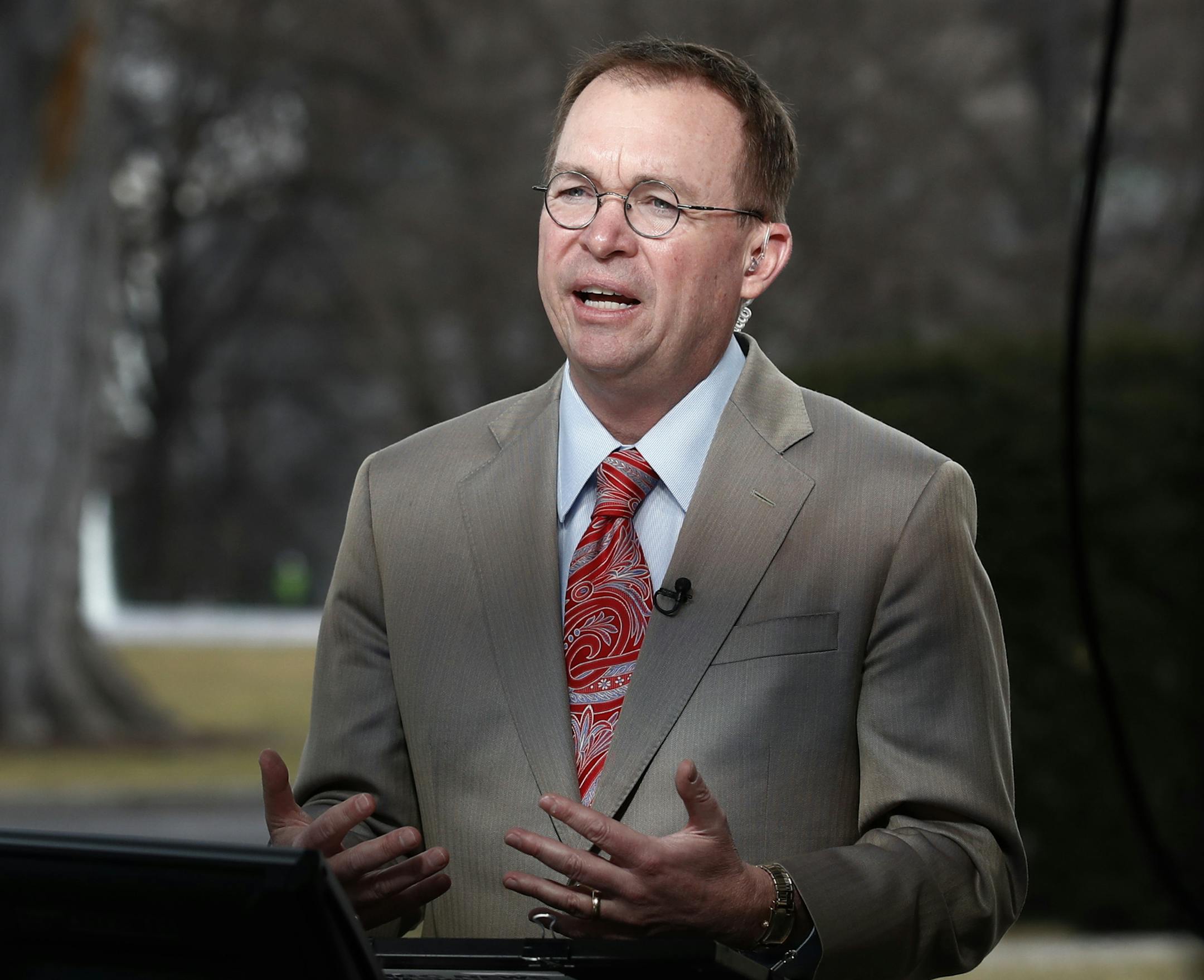 Director of the Office of Management and Budget Mick Mulvaney talks during a television interview outside the White House in Washington, Monday, Jan. 22, 2018. Mulvaney is defending President Donald Trump's lack of outreach to Democratic lawmakers during the government shutdown. (AP Photo/Carolyn Kaster)