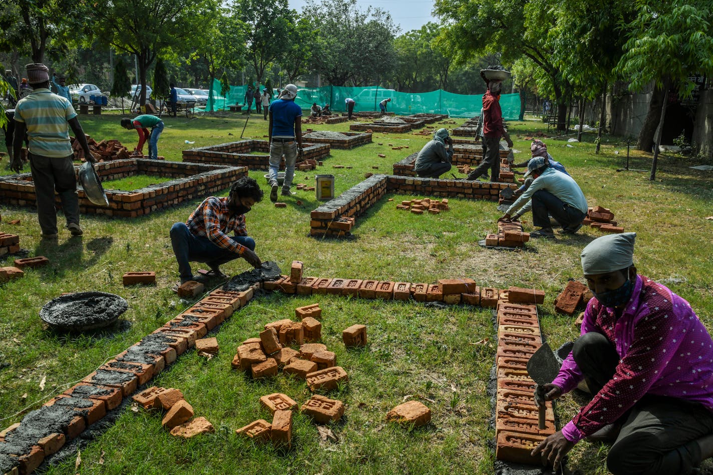 Workers build new platforms to expand a mass cremation site in New Delhi, April 27, 2021. Some doctors, the public and media point to anecdotal evidence of infections even among the vaccinated to blame a coronavirus variant on the country's deepening crisis, but scientists say the data is too thin and cite other reasons behind the country's second wave. (Atul Loke/The New York Times)