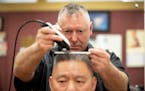Bob Haddow cuts the hair of longtime client Alan King, a civil litigation and criminal defense attorney, Wednesday, March 29, 2023 at the Grain Exchan