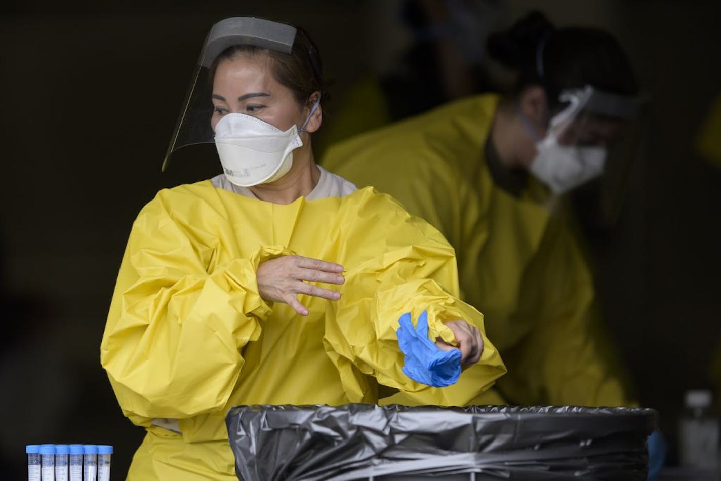 Elizabeth Santoro, a medic with the Minnesota Air National Guard 133rd Medical Group, tossed her gloves after administering a COVID-19 test Saturday afternoon.