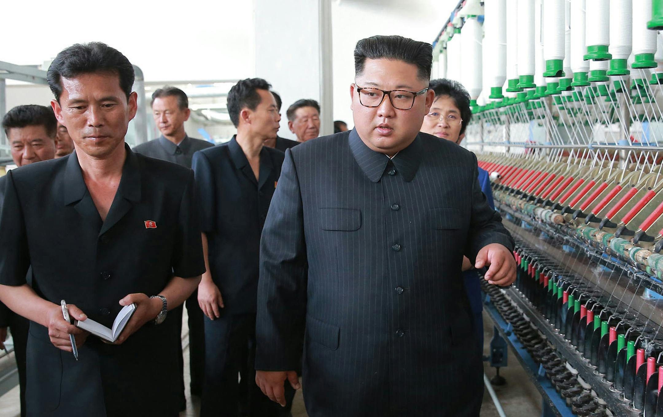 In this undated photo provided on July 2, 2018, by the North Korean government, North Korean leader Kim Jong Un, center, visits Sinuiju Chemical Fibre Mill in Sinuiju, North Korea. Independent journalists were not given access to cover the event depicted in this image distributed by the North Korean government. The content of this image is as provided and cannot be independently verified. Korean language watermark on image as provided by source reads: "KCNA" which is the abbreviation for Korean