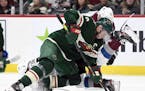 Minnesota Wild's Mikko Koivu (9), of Finland, takes control of the puck after a face-off against the Colorado Avalanche during the second period of an