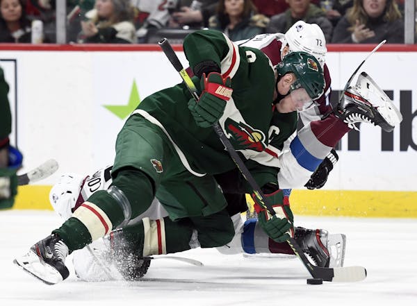 Minnesota Wild's Mikko Koivu (9), of Finland, takes control of the puck after a face-off against the Colorado Avalanche during the second period of an