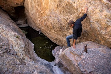 U.S. Fish and Wildlife Service senior fish biologist Michael Schwimm climbs down into Devil’s Hole Friday, April 29, 2022, in Ash Meadows National W