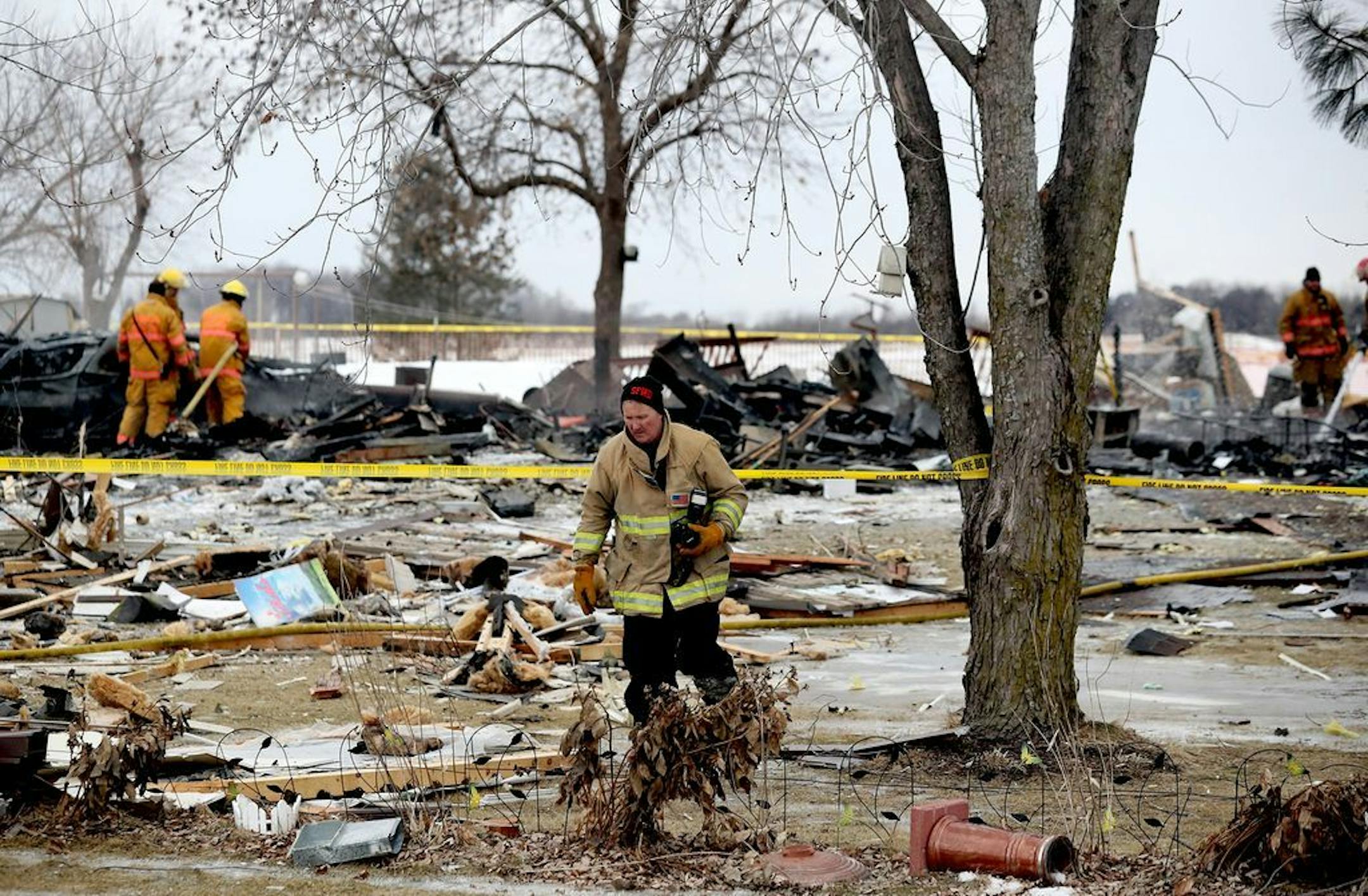 Firefighters sift through the rubble after one person died and another was seriously injured following a house explosion Tuesday, Feb. 5, 209, in the southern Dakota County community of Hampton, MN.