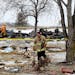 Firefighters sift through the rubble after one person died and another was seriously injured following a house explosion Tuesday, Feb. 5, 209, in the 