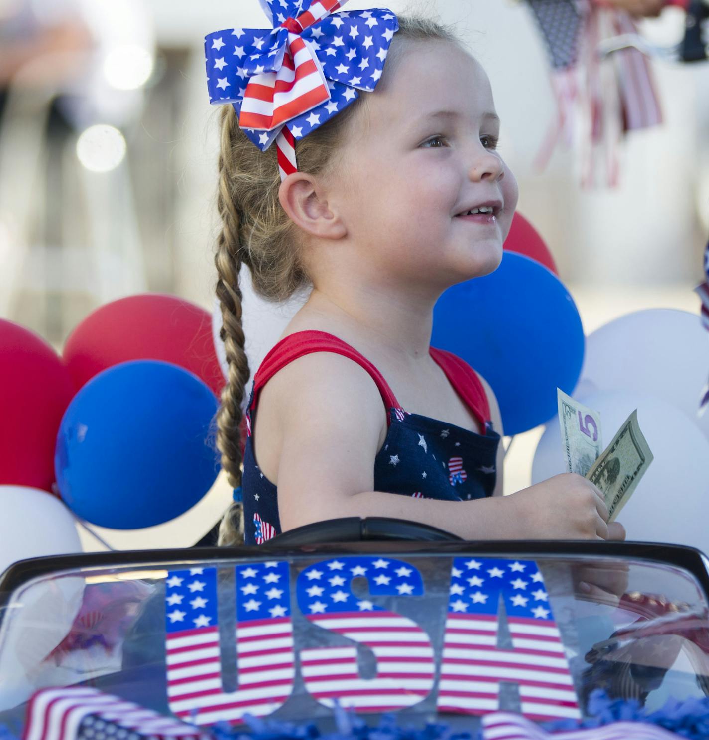 Eleana Callam smiles after collecting her $25 reward for being a winner in the kiddie parade on Monday.