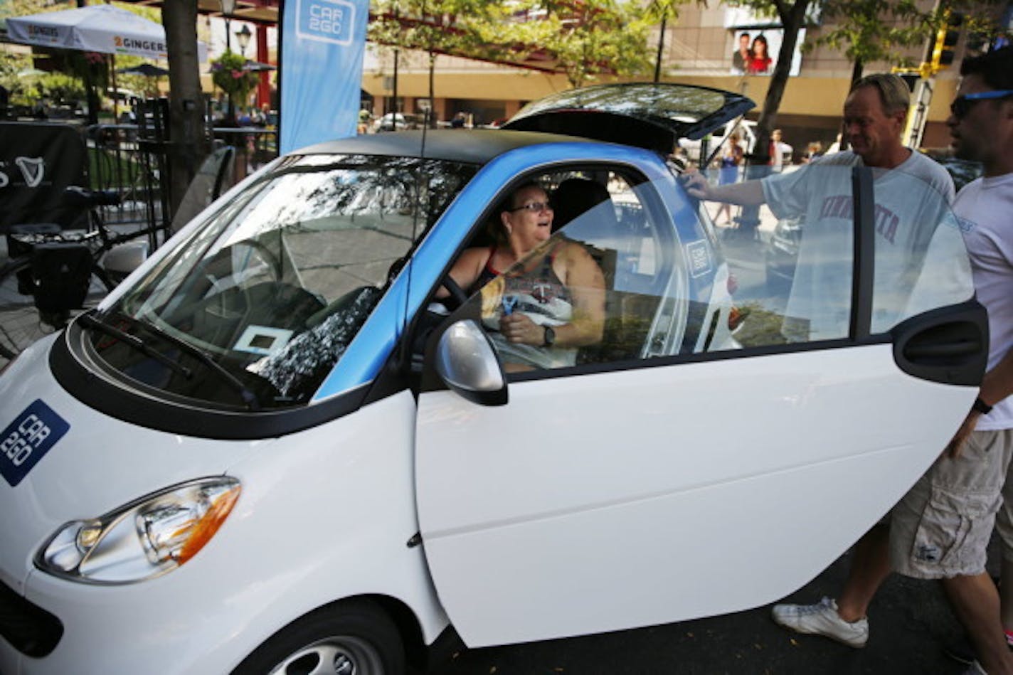 Pam Terink of St. Paul, who uses Nice Ride bicycles when the weather is nice, checked out a Car2Go when the company first began operations in Minneapolis.