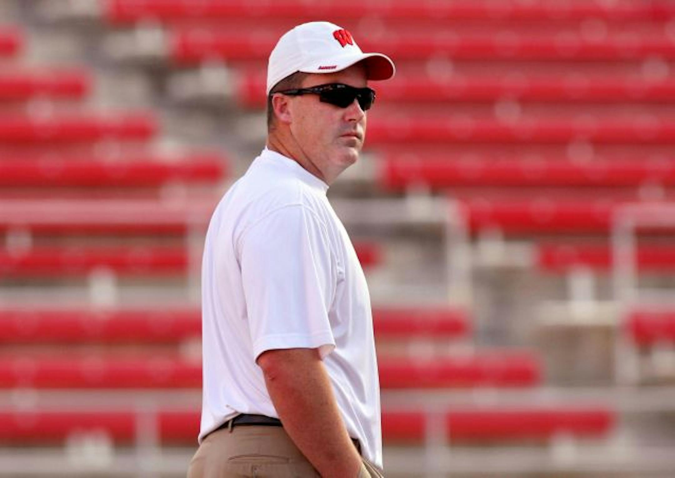 Paul Chryst, the offensive coordinator and quarterbacks coach, watches his players loosen up before the game. The Wisconsin Badgers traveled to Sam Boyd Stadium to take on the UNLV Rebels Saturday, September 8, 2007, in Las Vegas, Nev . WSJ/John Maniaci (Published caption 12/29/07) "It's like most decisions -- you don't look back," UW's Paul Chryst said of tuning down a job with the Dallas Cowboys last February.