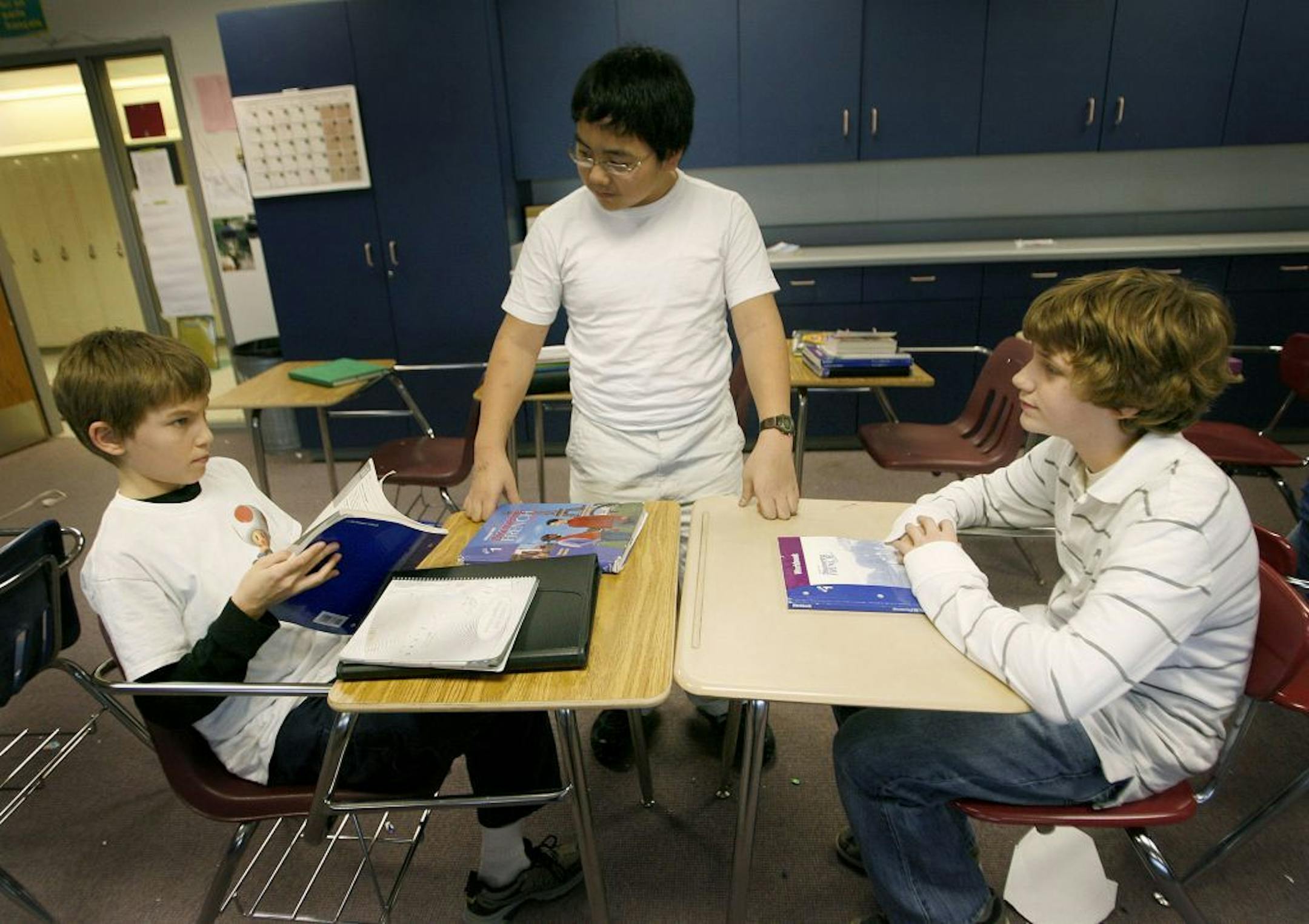 Parents at Capitol Hill Gifted and Talented Magnet in St. Paul are enraged over district plans to cut that school's budget while also reducing its enrollment — despite a healthy waiting list. Pictured: Students Simon Fink, left, George Tchang, center, and Jona Busch worked on a project in French class at the school in 2008.