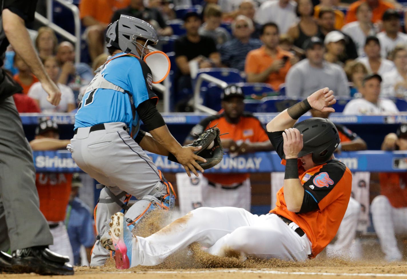 The U.S. Team's Chance Sisco of the Baltimore Orioles beat the throw to World Team catcher Francisco Mejia of the Cleveland Indians to score during the second inning of the All-Star Futures game Sunday.